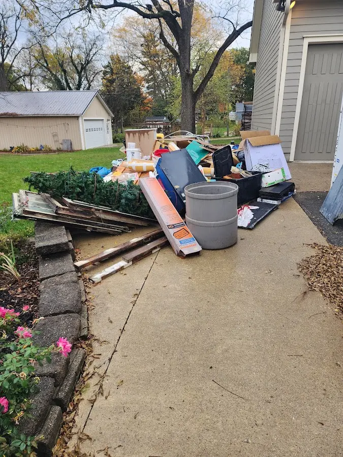 Dumpster being loaded with debris for 12 Yard Dumpster Rental in Zion